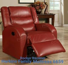 a red recliner chair sitting on top of a hard wood floor