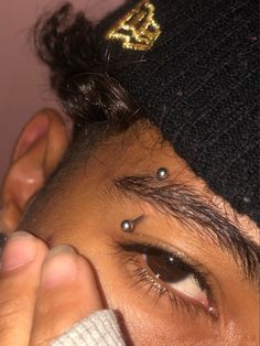 a person with piercings on their forehead