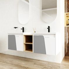 a white bathroom with two sinks and mirrors on the wall next to a wooden floor