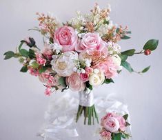 a vase filled with pink and white flowers