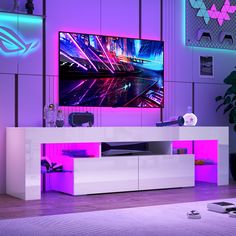 an entertainment center in a living room with purple lighting