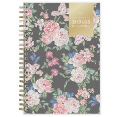 a planner with flowers on the cover and gold foil lettering, in black background that reads