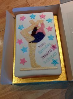 a birthday cake in the shape of a woman's figure with stars on it