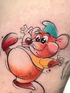 a cartoon mouse tattoo on the thigh