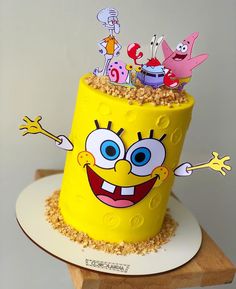 a spongebob cake on a white plate with sprinkles and decorations