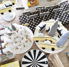 a table topped with plates and desserts covered in frosting