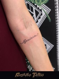 a woman with a tattoo on her arm that reads, beshabo tattoo in cursive writing