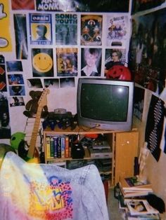 a living room filled with lots of clutter and pictures on the wall above it