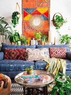 a living room filled with furniture and lots of plants