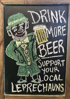 a chalk board with a drawing of a leprechaun holding a beer