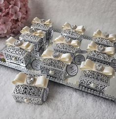 there are many silver boxes with bows on them