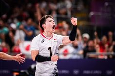 a male volleyball player celebrating his team's victory