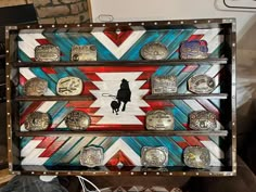 a wooden box filled with lots of different types of belts