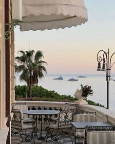 an outdoor dining area overlooking the ocean