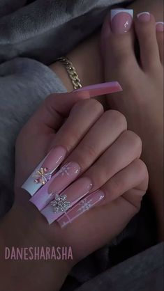 a woman's hands with pink and white nail polish