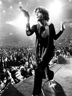 a man standing on top of a stage in front of an audience