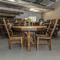 a wooden table with chairs around it in a room full of other tables and chairs