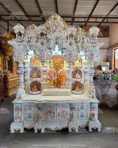 an elaborately decorated white and gold shrine