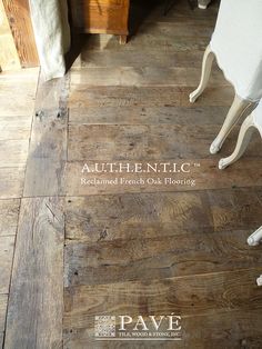 an old wooden floor with white furniture in the background