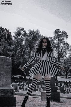 a woman dressed in black and white striped clothes