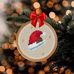 a cross stitch ornament hanging from a christmas tree