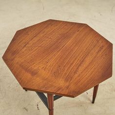 an octagonal wooden table with two legs