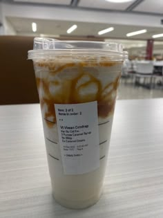 a plastic cup filled with liquid on top of a table