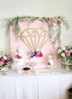 a table topped with lots of cake and balloons