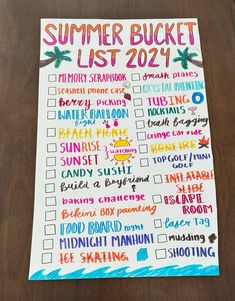 a summer bucket list on top of a wooden table