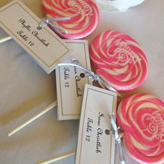 candy lollipops with labels on them sitting on a table