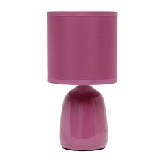 a pink table lamp with a purple shade on the base and a white light behind it