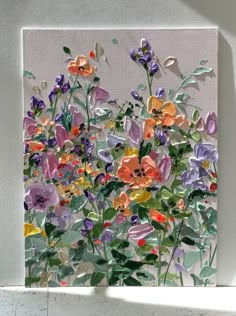 a painting of flowers on a white wall