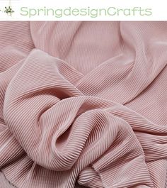 an image of a pink fabric that looks like it has been pleated in the wind