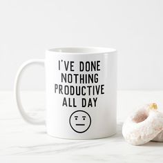 a white coffee mug with a donut next to it that says i've done nothing productive all day