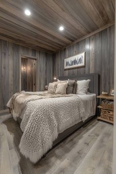 a bedroom with wood paneling and white fur on the bedspread is shown