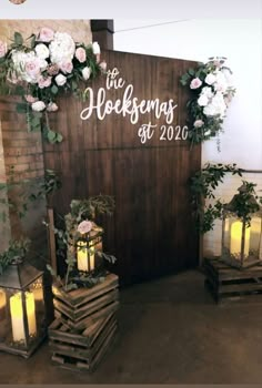 wedding decorations made out of wooden pallets with flowers and greenery on the wall