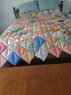 a bed with a quilt on top of it