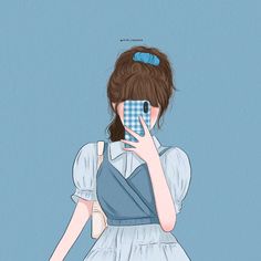 a girl in blue dress holding up a cell phone to her face with both hands