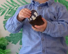 a young boy holding a chocolate cupcake in his hands