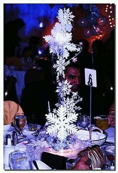 a man is sitting at a table with snowflakes on it