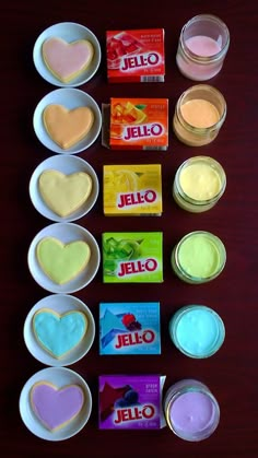 the ingredients for jello are arranged in small bowls on a wooden table with chocolates and candies