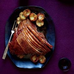 a large piece of meat on a plate with potatoes