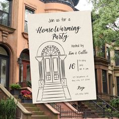 a housewarming party sign hanging from the side of a building with steps leading up to it