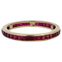 a yellow gold ring with ruby stones