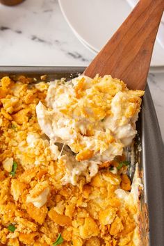 a casserole dish with chicken and rice in it on a marble counter top