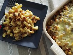 a casserole dish with macaroni and cheese on it next to a fork