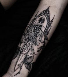 a black and white tattoo design on the arm