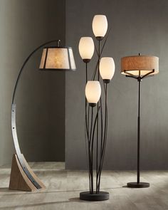 the floor lamp has five lamps on it and is next to a circular light fixture