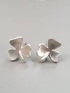 Adorable small  studs in shamrock shape. The material is sterling silver and the surface is brushed.They are about 0.3" ×0.35" (8x9mm)The earrings come in a gift box.All jewellery in my shop I design and make in my workshop near Belfast, Northern Ireland. Shamrock Shape, Silver Shamrock, Irish Clover, Belfast Northern Ireland, Irish Jewelry, Lucky Clover, Luck Of The Irish, Studs Earrings, Enamel Jewelry