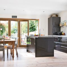 an open kitchen and dining room with sliding glass doors